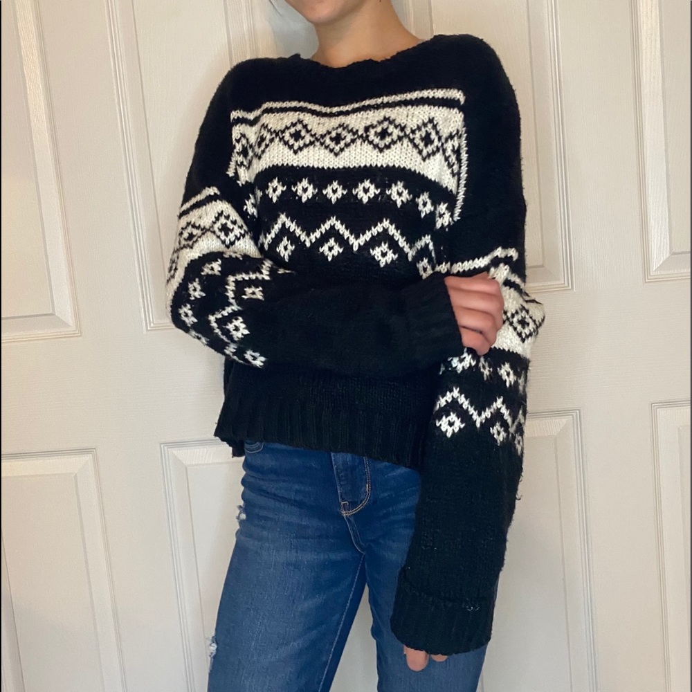 Warm black knit sweater with white designs